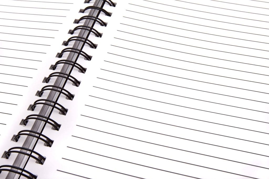 Close-up of blank pages in a spiral notebook